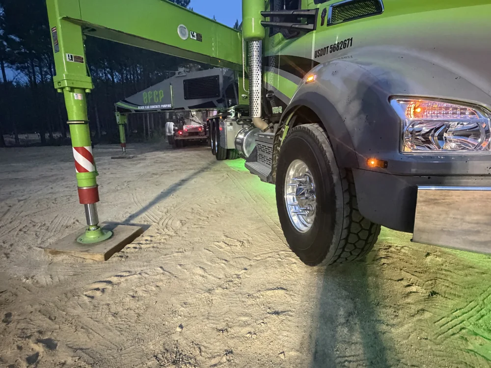 Black Flag truck with an outrigger deployed at a night jobsite